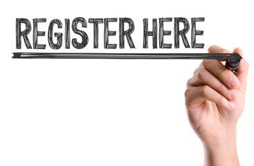 Hand with marker writing the word Register Here