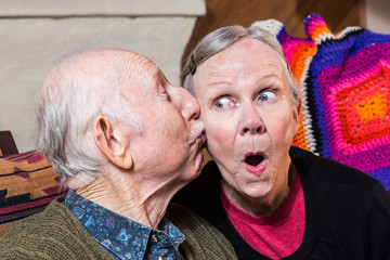 Elderly Gentleman Kissing Elderly Woman on Cheek