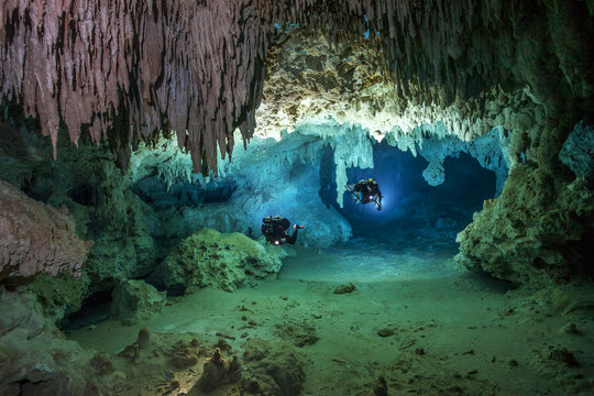 Two cave divers exploring cave system of Cenote Chan Ho