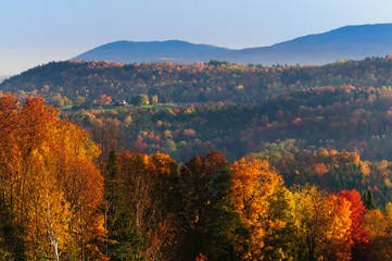 Landscape view of a morning sunrise during fall foliage season.