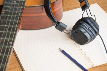 headphone guitar notebook and pencil