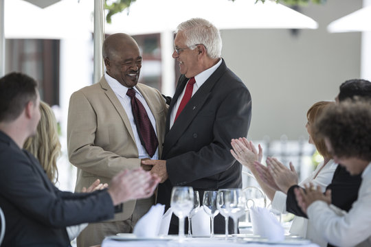 Businesspeople celebrating achievements in restaurant - Powered by Adobe