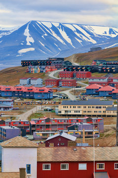 Looking over numerous colorful buildings, in Longyearbyen, Svalb