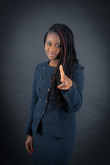 Fototapeta premium Beautiful woman doing different expressions in different sets of clothes: gun sign