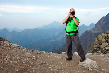 Photographer taking a photo in the mountains