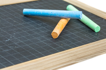 colored chalk placed on a school slate