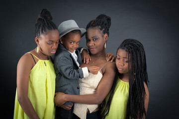 Obraz premium Beautiful family doing different expressions in different sets of clothes: sad