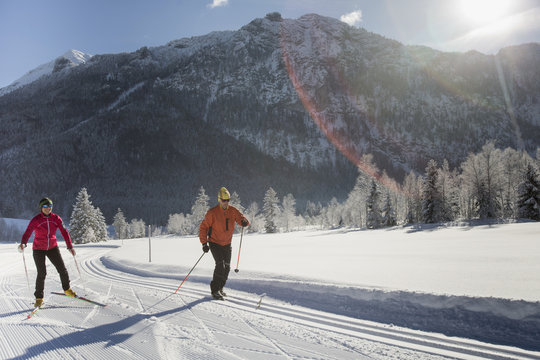 Germany, Bavaria, Inzell, two skiers in snow-covered landscape
