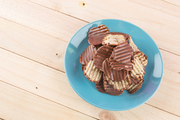 potato chip with chocolate on wood