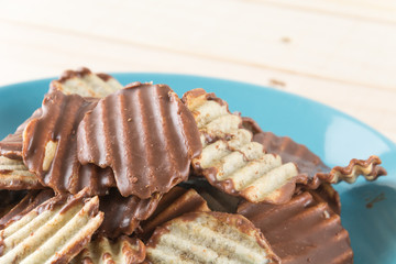 potato chip with chocolate on wood