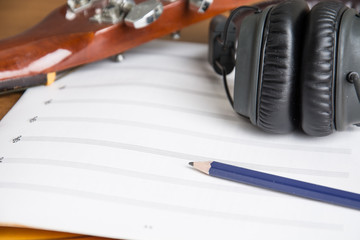 headphone guitar notebook and pencil