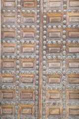 Exterior, old wooden door Castilian style in Toledo Spain