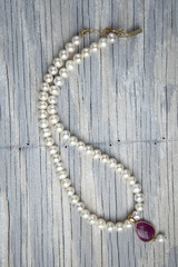 Necklace on old wooden table