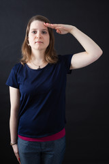 Fototapeta premium Beautiful woman doing different expressions in different sets of clothes: at attention