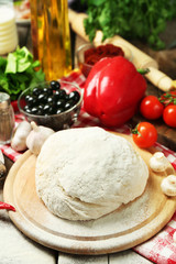 Food ingredients for pizza on table close up