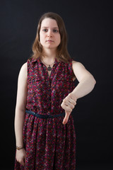 Beautiful woman doing different expressions in different sets of clothes: thumbs down