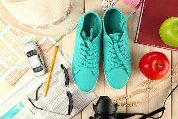 Female gumshoes with accessories on wooden background