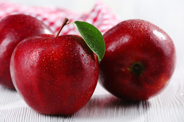 Ripe red apples on table close up