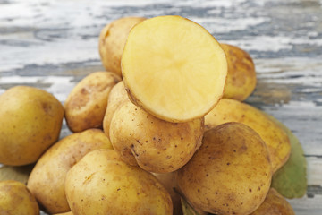 Young potatoes on wooden table close up