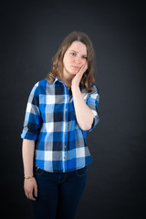 Beautiful woman doing different expressions in different sets of clothes: toothache