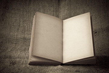 Stock Photo:.old book open blank pages, empty yellow paper on da
