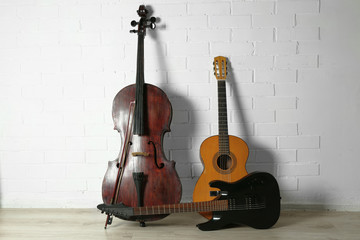 Musical instruments on white brick wall background