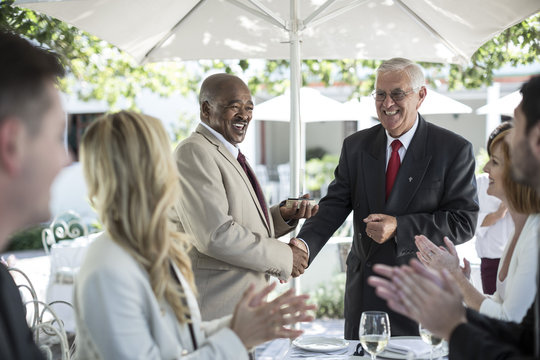 Businesspeople celebrating achievements in restaurant