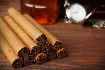 Cigars on wooden table, closeup