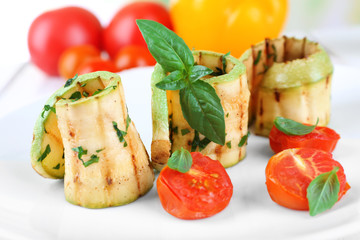 Grilled rolls of vegetable mallow in white plate on table, closeup
