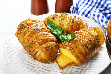 Baked potatoes on wooden table, closeup