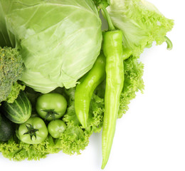 Heap of green vegetables isolated on white