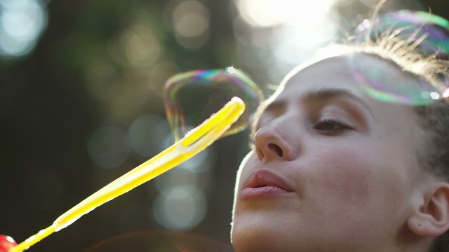 Girl Blowing bubbles in nature  