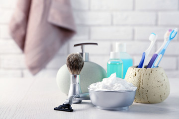 Male luxury shaving kit on shelf, on bricks wall background