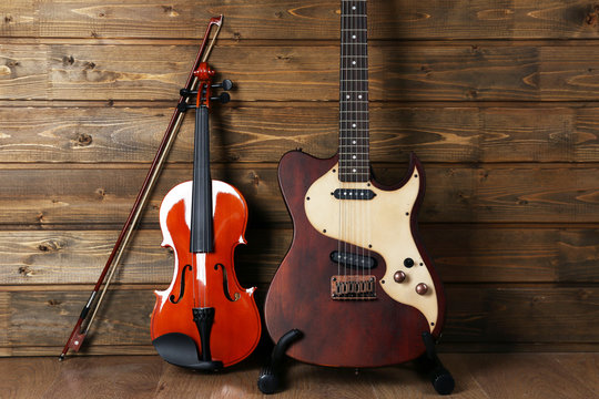 Electric and violin on wooden background