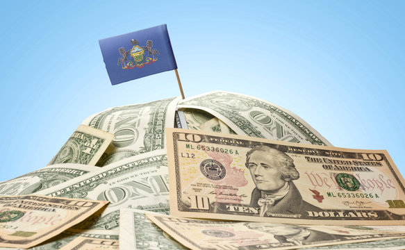 Flag of Pennsylvania sticking in a pile of american dollars.(ser