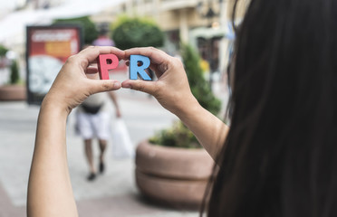 Bulgaria, Hands holding letters PR, pedestrian area