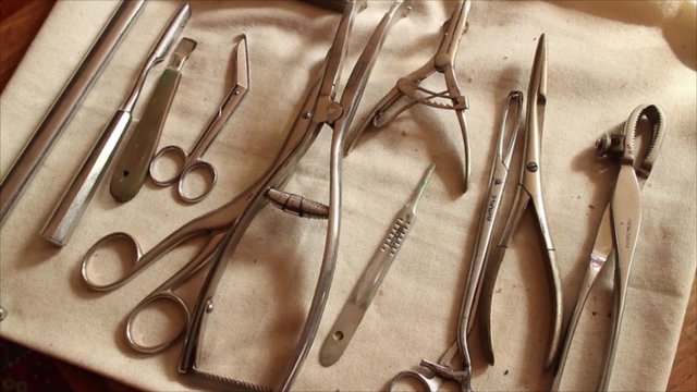 Vintage Medical Instruments - Excellent Overhead Rotational Dolly above Surgical Gear, Forceps,and Scalpels
