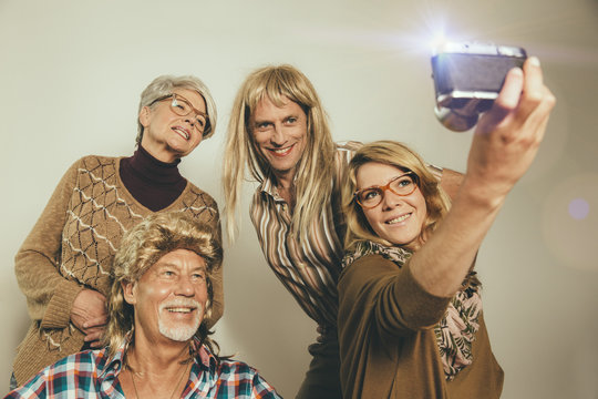 Family dressed like in the Eighties taking a selfie