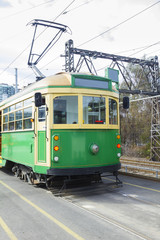 Fototapeta na wymiar Melbourne’s green and yellow classic tram