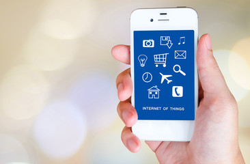 The internet of things on smart phone screen over blur bokeh lig