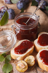 Freshly brewed homemade plum jam and toast close-up. vertical 
