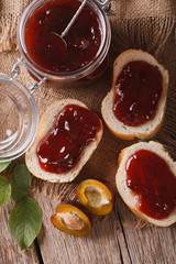 Sandwiches with plum jam close-up on the table. Vertical top view
