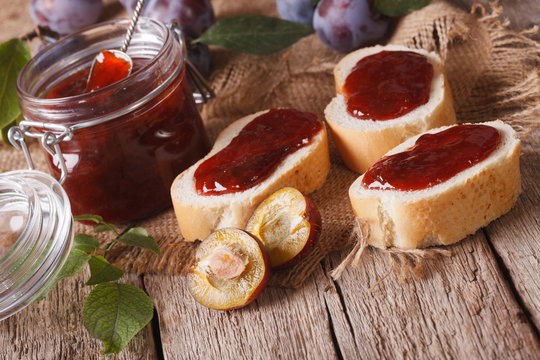 homemade plum jam and sandwiches close-up. horizontal
