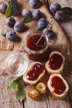 Freshly brewed plum jam and toast close-up. vertical top view
