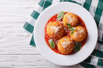 fried arancini rice balls with tomato sauce. horizontal top view
