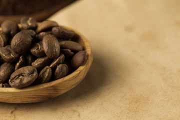 roasted coffee beans on old vintage open book. Menu, recipe, mock up. Wooden background.