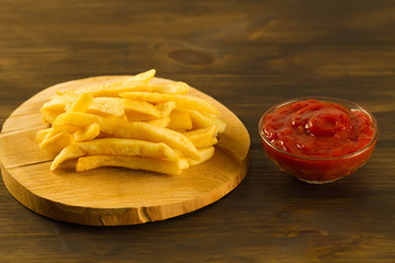 French  fries with fresh ketchup an old cutting Board