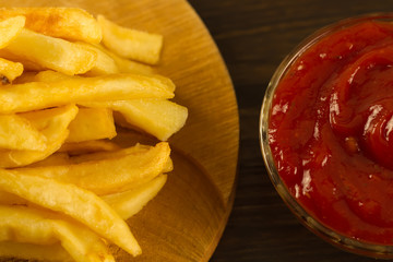 French  fries with fresh ketchup an old cutting Board