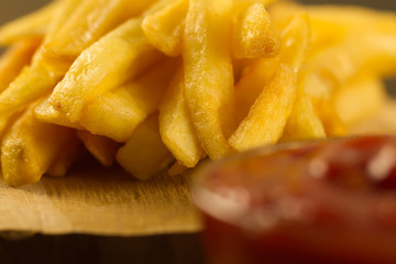 French  fries with fresh ketchup an old cutting Board, macro