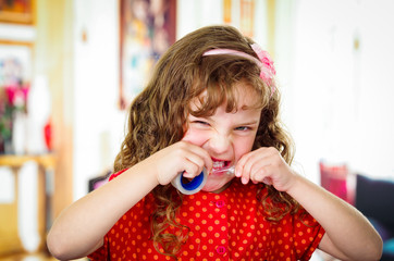 Little girl cutting adhesive tape